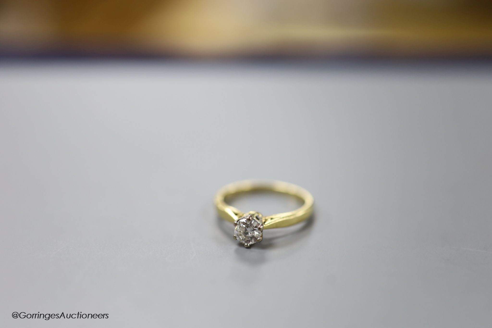 A modern 18ct gold and solitaire diamond ring, size L, gross weight 3.2 grams.